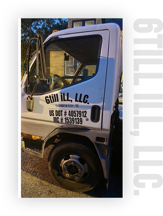 A white truck with the door open and the words " guil ll llc ".