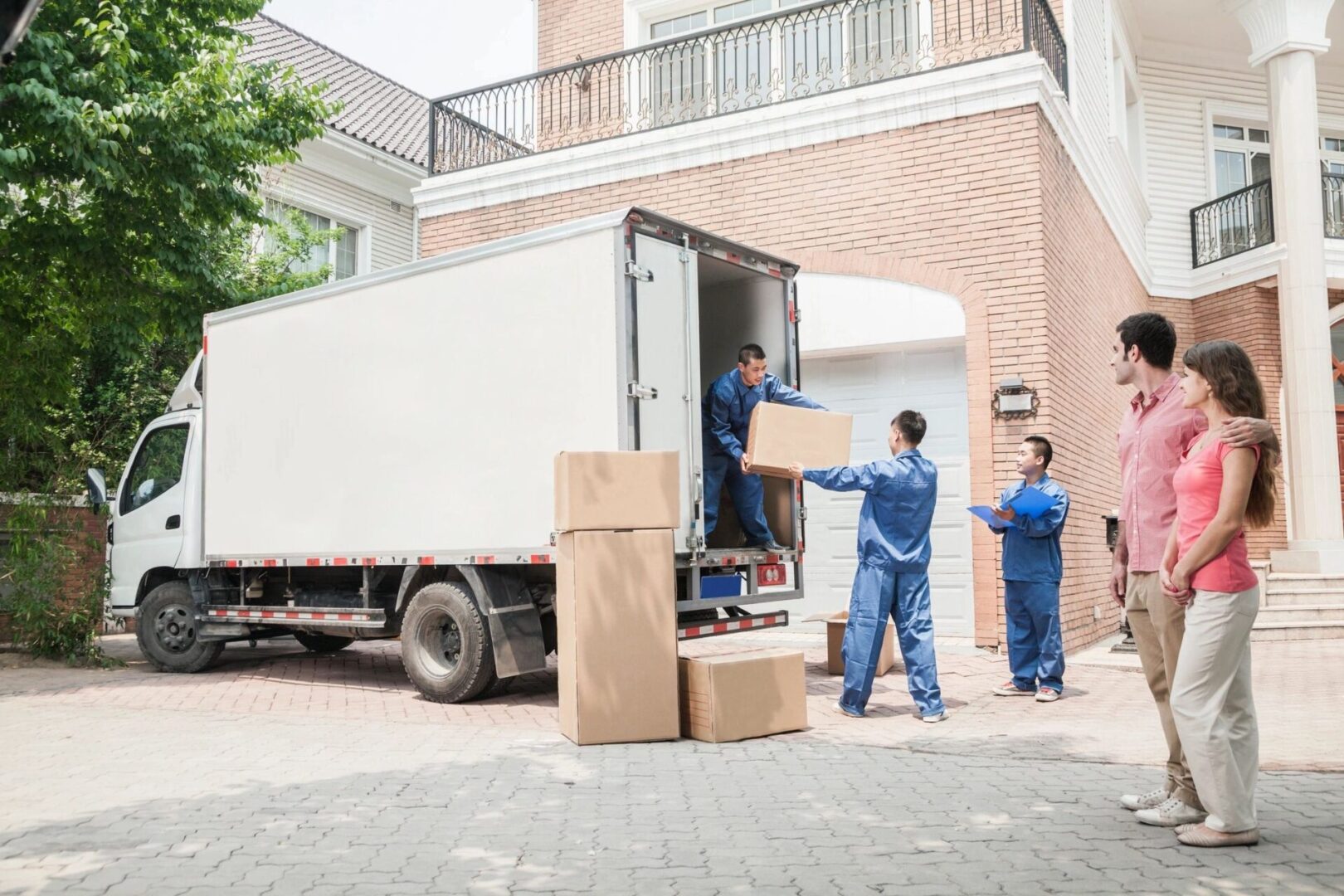 A group of people unloading boxes from a truck.