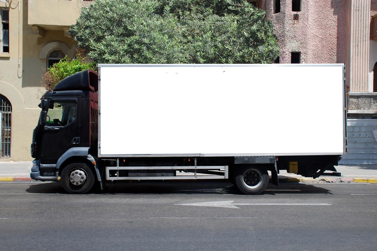 A truck with its side open parked on the street.